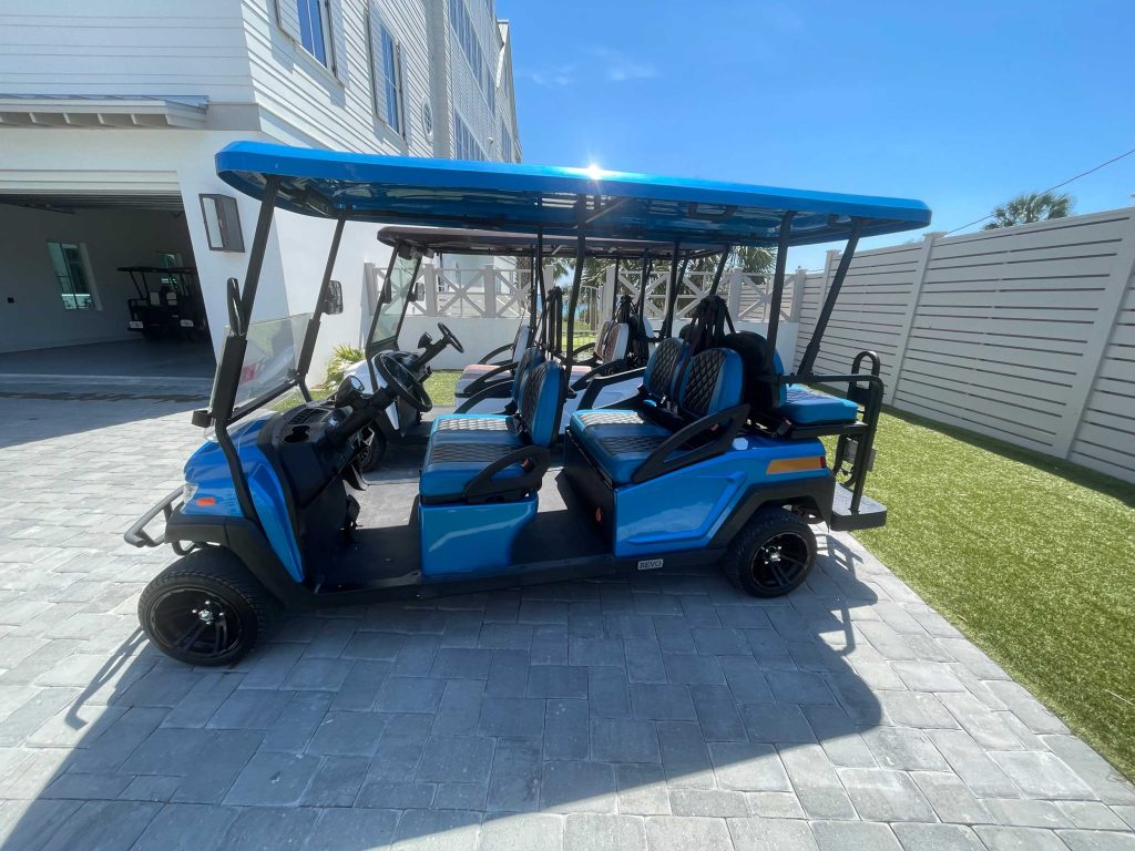 Two golf cart rentals parked at a vacation rental in 30A Florida.
